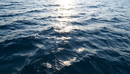 Sunlit ocean waves, dark blue hues, gentle undulation