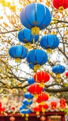 Vibrant blue and red lanterns hang from a tree, creating a festive atmosphere