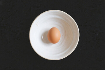 Brown Egg in White Ceramic Bowl Top View