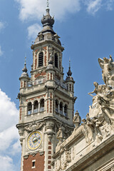 The Chamber of Commerce Belfry in Lille, Its ornate tower rises above the rooftops of the Grand...