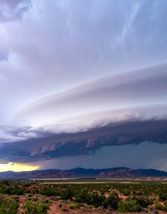 Dramatic storm clouds over desert landscape