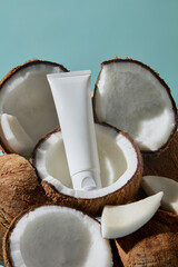 Coconuts in close-up framing a skincare product tube. This clean and fresh style highlights the natural power of coconut in skincare formulations. Mockup cosmetic bottle for design