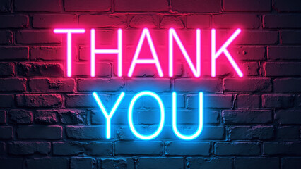 “THANK YOU” in pink and blue neon on brick wall.