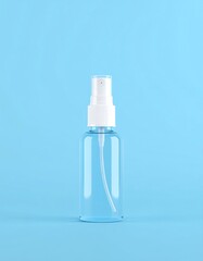 Clear spray bottle, light blue background