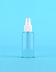 Clear spray bottle on blue background