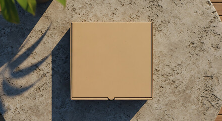 Overhead view of a closed, blank cardboard pizza box on a textured stone surface.