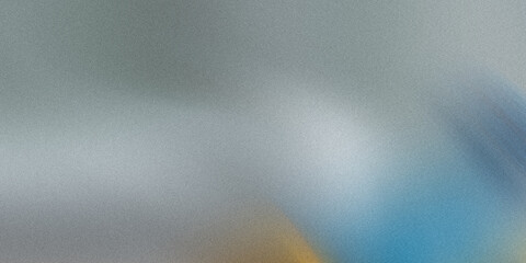 A grainy gray texture with hints of blue and yellow creates an abstract background, ideal for adding visual interest to designs
