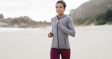 Running, health and fitness with woman at beach for sprint, cardio workout and sports training. Marathon practice, exercise and runner challenge with person outdoor for energy, athlete and wellness
