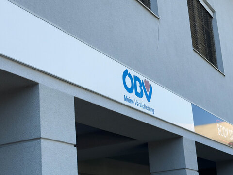 Villach, Austria - August 15, 2025: OBV insurance company sign displayed on a modern building exterior, showcasing branding and architectural elements in an urban setting