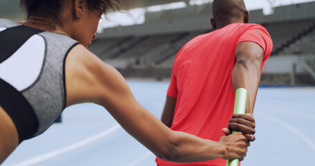 Team, hand and sprint with baton for relay, sports and fitness at race track. Running, competition and people pass stick at stadium for training, workout or cardio exercise for athletics from back