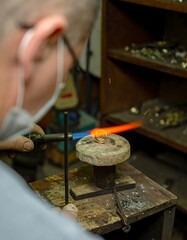Gold ring being heated in workshop