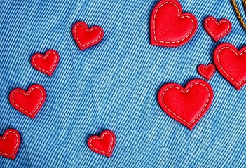 Obraz premium Charming denim texture with stitched hearts; perfect for Valentine's Day, closeup, embroidery