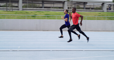 Athlete, people and running a race on track for competition practice, speed training and endurance. Runner, men and fast at stadium for fitness event, pace challenge and sports performance with space