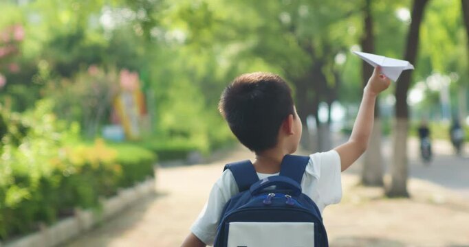 Chinese children happily go to school with airplanes in their backpacks