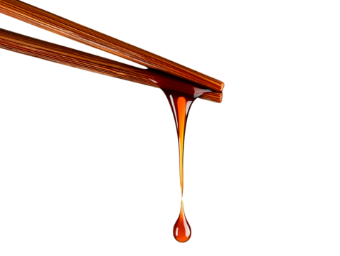  a liquid brown sauce dripping from chopsticks isolated on a transparent background