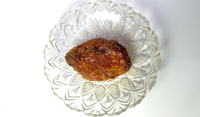 Fried Chicken Leg on Decorative Glass Plate in Bright Lighting