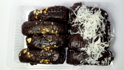 Dark Chocolate Banana Oat Cookies with White Shredded Cheese in Clear Plastic Container
