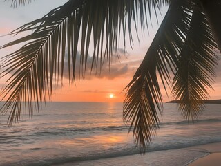 Fototapeta premium Tropical sunset over ocean with palm fronds in foreground beach palm tree