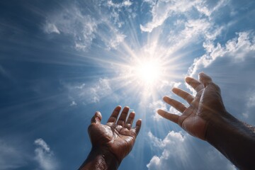Hands reach towards the bright sun in a blue sky filled with clouds, symbolizing hope and positivity in nature's embrace during the day