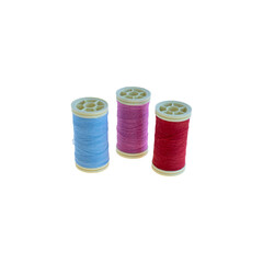 Colorful Sewing Thread Spools in Blue, Pink, and Red on White Background