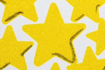 Close-up of many yellow stars on white