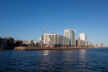 Fototapeta premium Panoramic view of modern residential and commercial buildings along the waterfront of the Elbe river in Hamburg