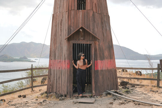 Beautiful young Asian woman posing in an abandoned lighthouse Golo Mori island, Labuan Bajo.