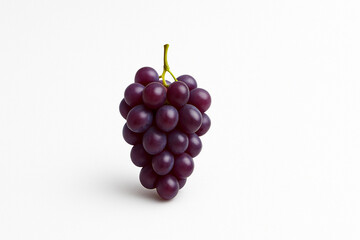 Fototapeta premium Minimalist bunch of purple grapes on clean white background