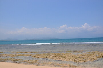 Obraz premium Sea background, beach and sand, sunny day, rock from waters, clear sky