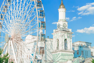 modern city historical architecture white bright urban environment with Ferris Wheel foreground summer Eastern European Ukrainian capital Kyiv destination sightseeing site for tourists