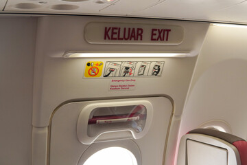 Emergency exit door in an airplane, airplane flight safety concept.