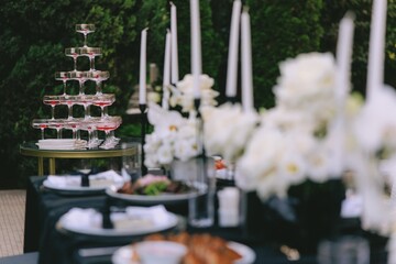 Elegant Outdoor Festive Table Setup with Champagne Tower.