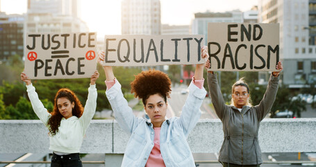 Portrait, women and protest poster in city for equality, end racism and justice peace. People, billboard and community fight for society freedom, inequality propaganda and sign for democracy movement