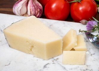 Pieces of matured pecorino romano italian cheese made from sheep milk in Lazio, Sardinia or Tuscany