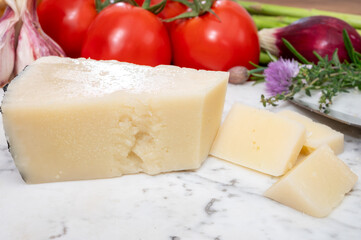 Pieces of matured pecorino romano italian cheese made from sheep milk in Lazio, Sardinia or Tuscany