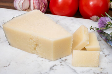 Pieces of matured pecorino romano italian cheese made from sheep milk in Lazio, Sardinia or Tuscany