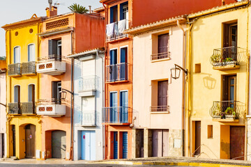 View of colourful Collioure, narrow streets and yellow, pink, orange houses, summer vacation destination town with historical buidings and beaches, Pyrenees-Orientales, France