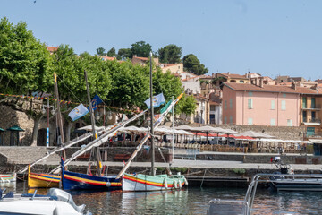 Fototapeta premium View of colourful Collioure, narrow streets and yellow, pink, orange houses, summer vacation destination town with historical buidings and beaches, Pyrenees-Orientales, France