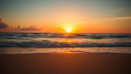 Serene beach sunset with golden tones and a softly focused horizon, creating a peaceful atmosphere.