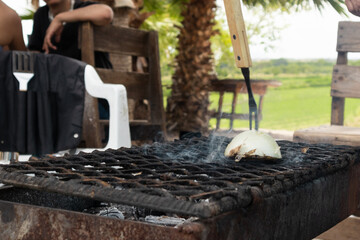 Chef grilling onion for roast beef in northern mexico
