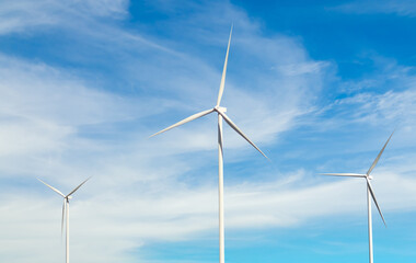 Fototapeta premium Wind mill power energy farm generator renewable sustainable field on blue sky, environment eco system technology industry ecology electricity power propeller turbine clean carbon.