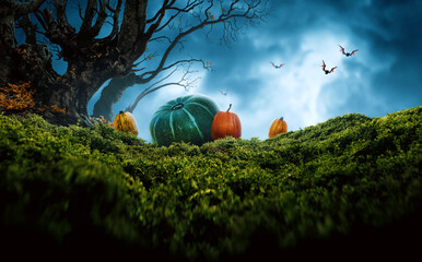 Spooky dark tree, pumpkins on grass and flying bats