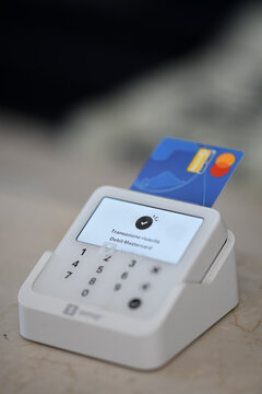 Modern payment terminal receiving a credit or debit card for secure contactless transactions in a retail or business environment