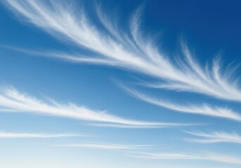 Beautiful wispy cirrus clouds streaking across a clear blue sky on a bright sunny day