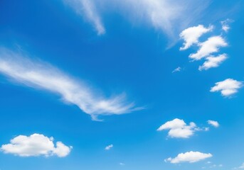 Vast blue sky with scattered white clouds on a bright sunny day, conveying a sense of peace and openness