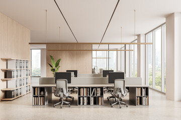 Modern open-plan office interior with minimalist workstations, wood accents, large windows, and neutral tones in bright corporate space. 3D Rendering