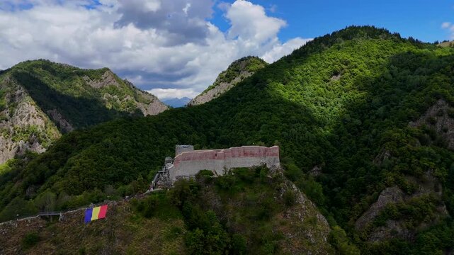 Orbiting aerial footage of the historic Poenari Castle, situated on top of a mountain in Romania