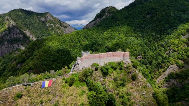 Orbiting aerial footage of the historic Poenari Castle, situated on top of a mountain in Romania
