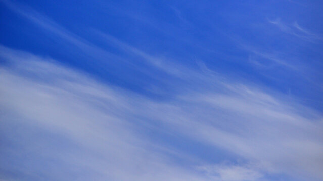 Beautiful cirrus clouds in the deep blue sky for a wallpaper