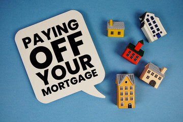 Paying Off Your Mortgage text with house models on blue background